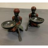 A pair of native women holding baskets/dishes
