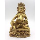 A Tibetan gilt bronze of god of wealth Jambhala, (19 cm high). Provenance: From the Sidhu Family