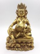 A Tibetan gilt bronze of god of wealth Jambhala, (19 cm high). Provenance: From the Sidhu Family