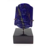 A Chinese lapis lazuli in form of a tablet, carved in shallow relief with a Namaskara Mudra Buddha