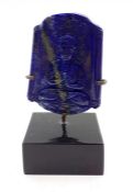 A Chinese lapis lazuli in form of a tablet, carved in shallow relief with a Namaskara Mudra Buddha