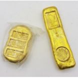A pair of Chinese gold coloured metal trade tokens ingots, with impressed character marks and a lion