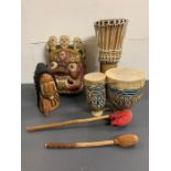 A selection of wooden carvings and two drums