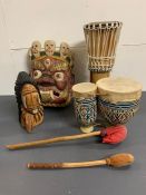 A selection of wooden carvings and two drums