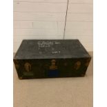 A vintage travel trunk with leather handles and brass corners