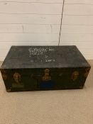 A vintage travel trunk with leather handles and brass corners