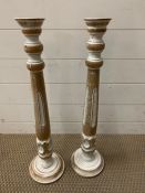 A pair of tall painted candlesticks