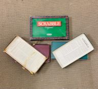 Three versions of the board game "Scrabble" of various ages