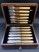 Two cased sets of fish knives and forks.