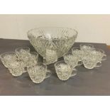 A cut glass punch bowl and twelve cut glass cups