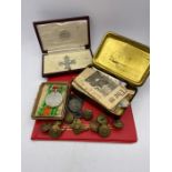 A Selection of Military ephemera to include a 1916 Christmas Tin, replica military cross, Defence