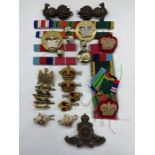 A Selection of Military insignias, buttons and medal bars, with a Royal Artillery background.