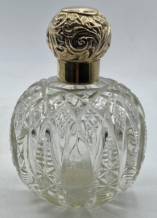 A Silver topped scent bottle, indistinct hallmark possibly Birmingham 1876.