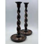 A pair of twisted oak candlesticks.