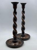 A pair of twisted oak candlesticks.