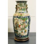 A large vase of slightly ribbed baluster form and folded rim with 'Famille verte' enamelled