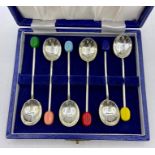 A cased box of mid Century coffee spoons with coloured coffee bean handles.