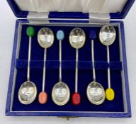 A cased box of mid Century coffee spoons with coloured coffee bean handles.