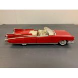 A red model Cadillac car by Maistro