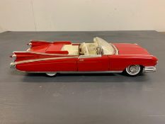 A red model Cadillac car by Maistro