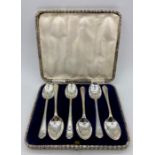 A Boxed set of six golf themed teaspoons by Walker & Hall, dated Sheffield 1933.