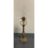 A vintage oil lamp on metal base