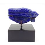 A carved lapis lazuli in the form of the Eye of Horus, (5.2 cm long). Provenance: From the Sidhu