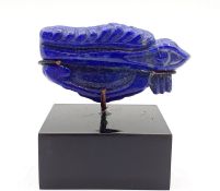 A carved lapis lazuli in the form of the Eye of Horus, (5.2 cm long). Provenance: From the Sidhu