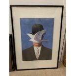 A framed poster of "The man with a bowler hat - Bird before Face" by Rene Magritte