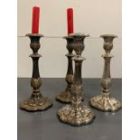 A set of four silver plated candlestick decorative with flowers and leaves