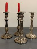 A set of four silver plated candlestick decorative with flowers and leaves