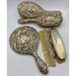 A selection of silver backed dressing table brushes and a mirror