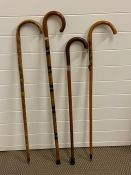 Four walking sticks, some silver mounted