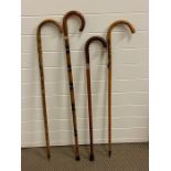 Four walking sticks, some silver mounted