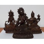 A group of three figures in bronze and cast iron representing Tara and Guanyin. (17 cm largest).