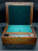 A 19th century walnut writing slope with fitted interior and brass handles (11.5x30.5x25 cm).