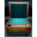 A 19th century walnut writing slope with fitted interior and brass handles (11.5x30.5x25 cm).
