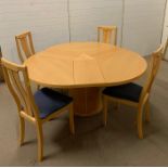 A Skovby round extending dining table made in Denmark, with four chairs (H74cm Diam 149cm)