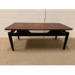 A G-Plan Tola coffee table on black ebonized legs (H40cm W100cm D49cm)