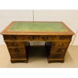 A pedestal desk with leather top
