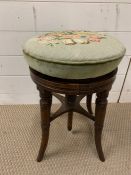 A Victorian Mahogany Piano Stool with adjustable height.