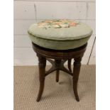 A Victorian Mahogany Piano Stool with adjustable height.