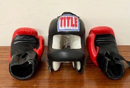 A pair of boxing gloves and head shield