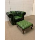 A green button back Chesterfield chair and foot stool (H72cm W100cm D85cm)