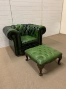 A green button back Chesterfield chair and foot stool (H72cm W100cm D85cm)