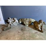 Four small garden ornaments of various sizes