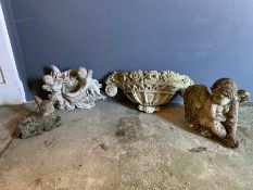 Four small garden ornaments of various sizes