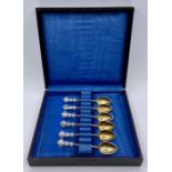 A boxed set of silver and enamel coffee spoons