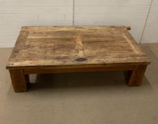 An oak coffee table made in Mexico, possibly made from an old door (H45cm W160cm D88cm)