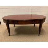 A mahogany coffee table of a oval shape with inlay and drawers to sides (H45cm W107cm D56cm)